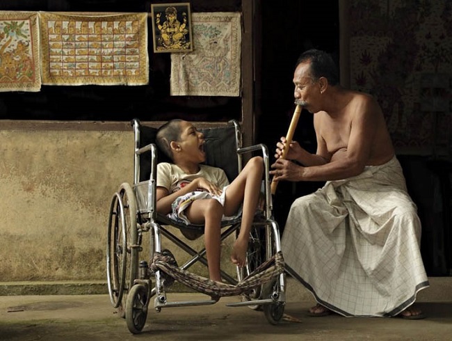 Man entertaining disabled child Man entertaining disabled child