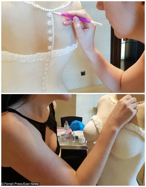 The bride cake can be seen wearing a necklace as well The bride cake can be seen wearing a necklace as well